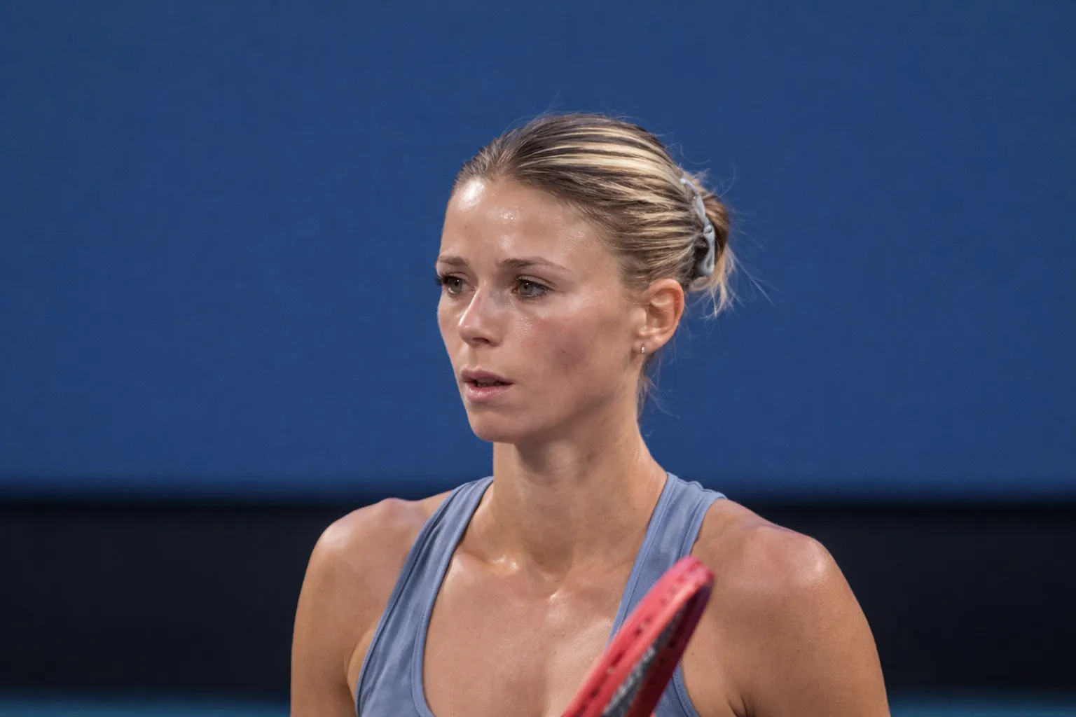 Camila Giorgi focused during a match in Miami 2024, fueling speculation about a possible comeback from retirement in professional tennis.