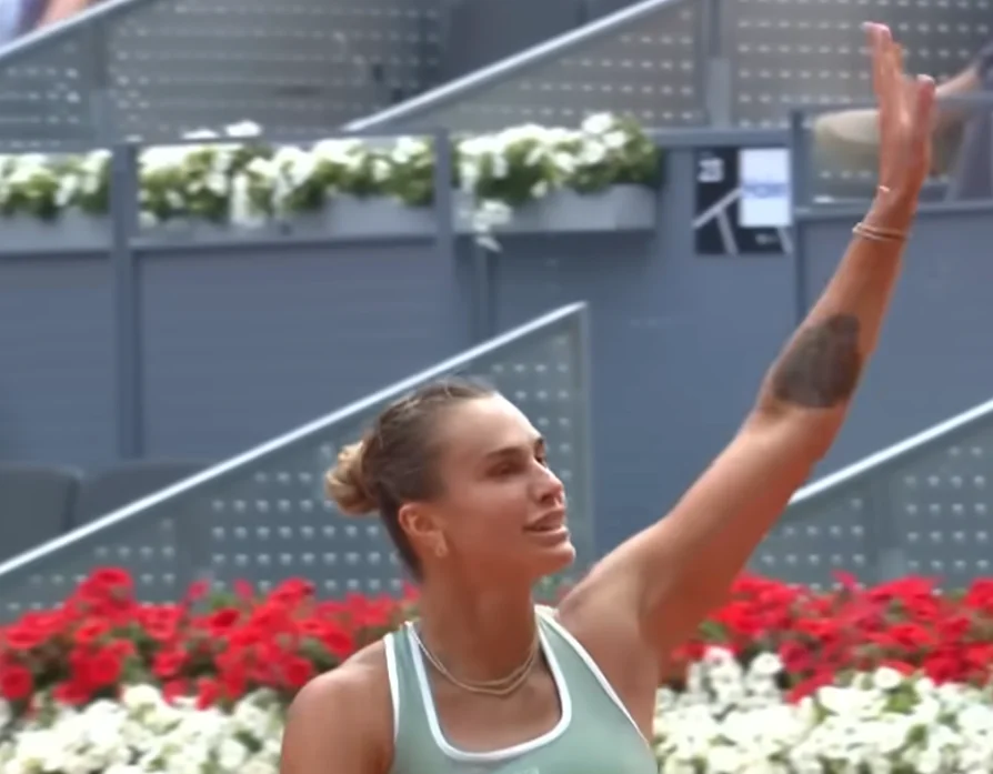 Aryna Sabalenka waves to the crowd after advancing to the third round at the Madrid Open