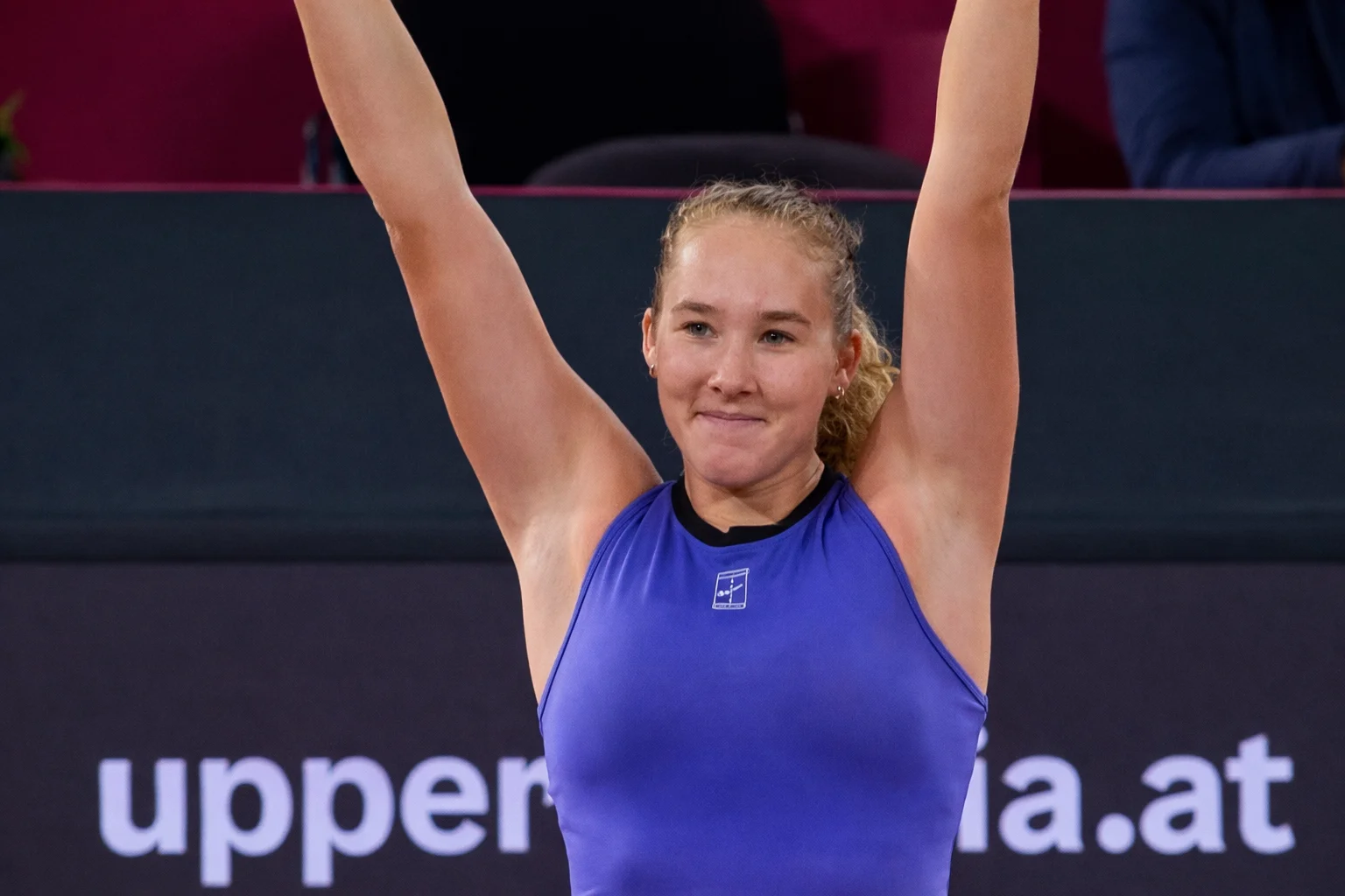Mirra Andreeva celebrates with arms raised after defeating Sorana Cirstea at the Linz 2026 tournament.