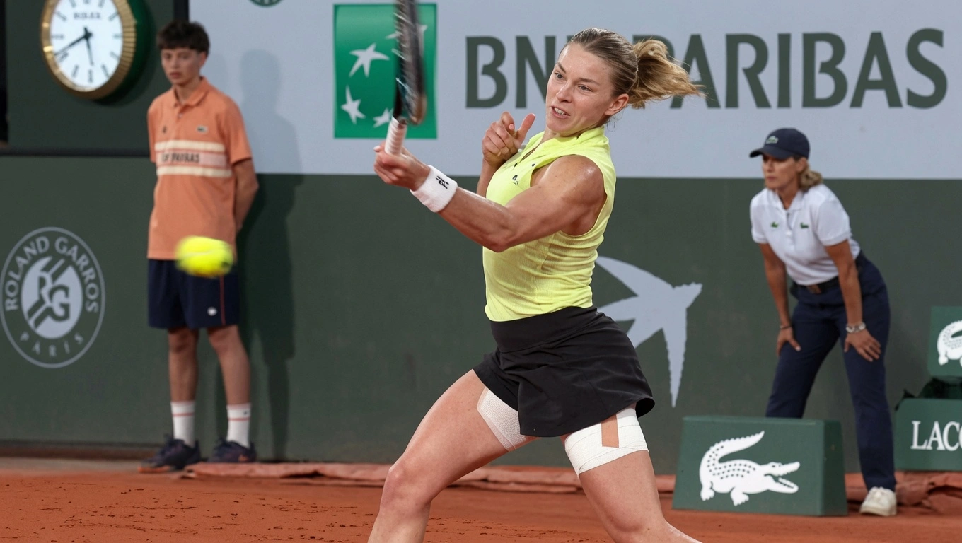 Maja Chwalinska hitting a powerful forehand during her French Open 2026 match on the red clay courts at Roland Garros in Paris