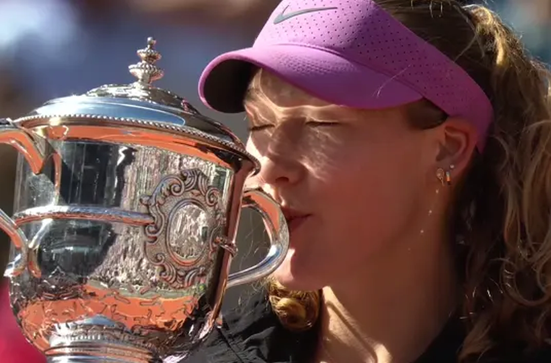 Mirra Andreeva kisses the 2026 French Open trophy after becoming the first Russian Grand Slam champion since Maria Sharapova in 2014 on the same court