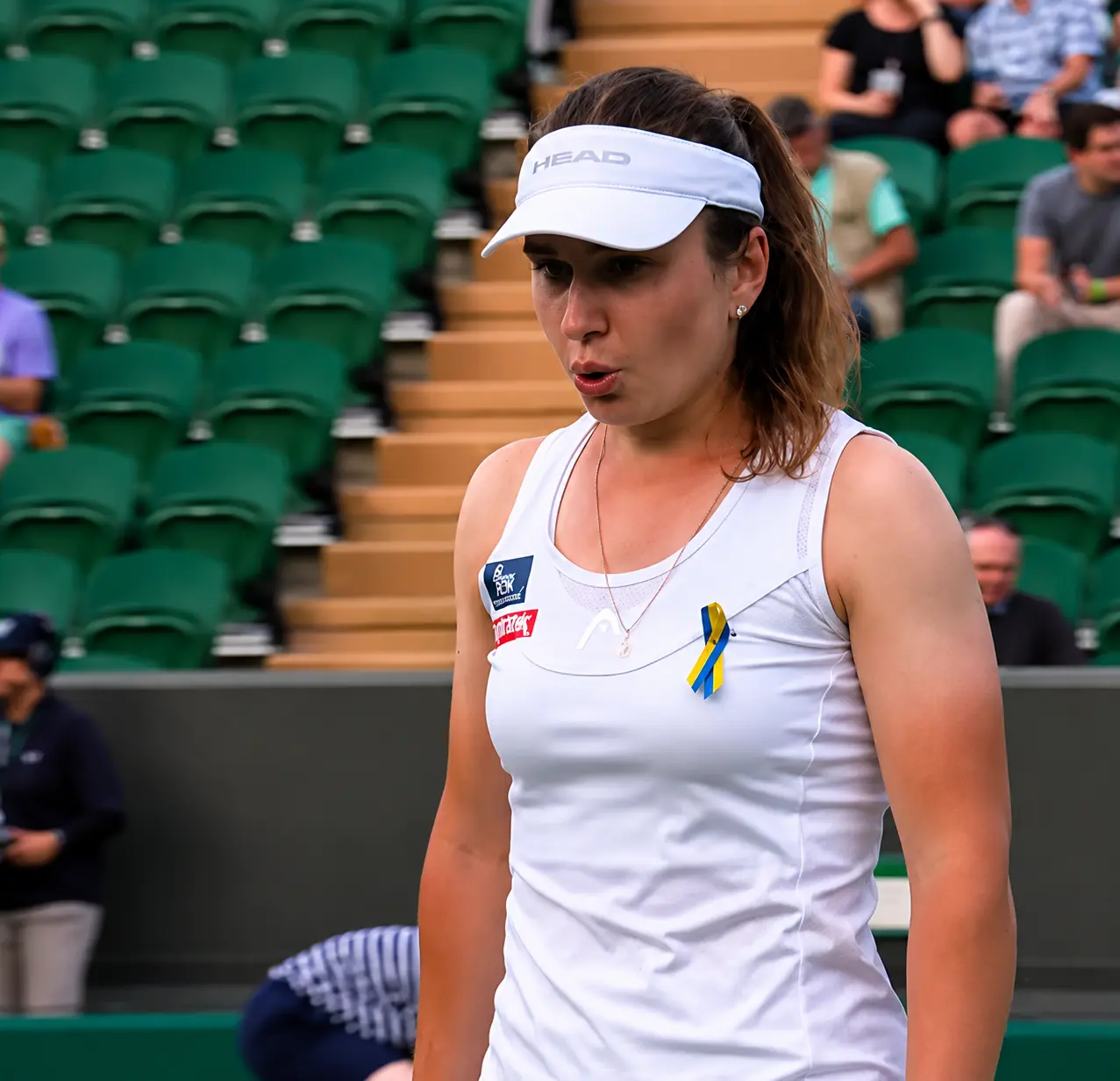 Daria Snigur focuses between points during her Wimbledon 2026 women's singles match on the grass courts of the All England Club