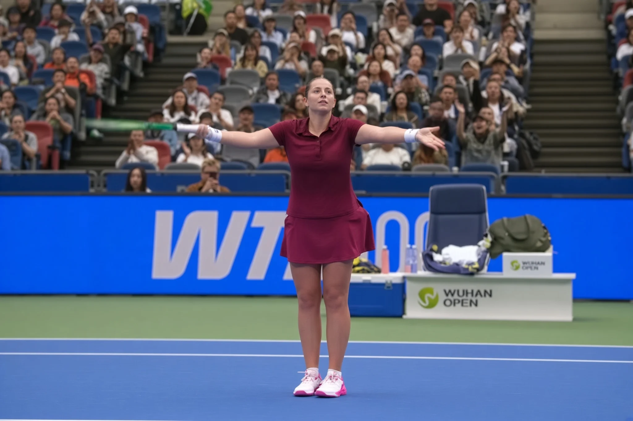 Jelena Ostapenko gestures to the Wuhan crowd after winning the first set against Diana Shnaider in their 2026 Wuhan Open quarterfinal